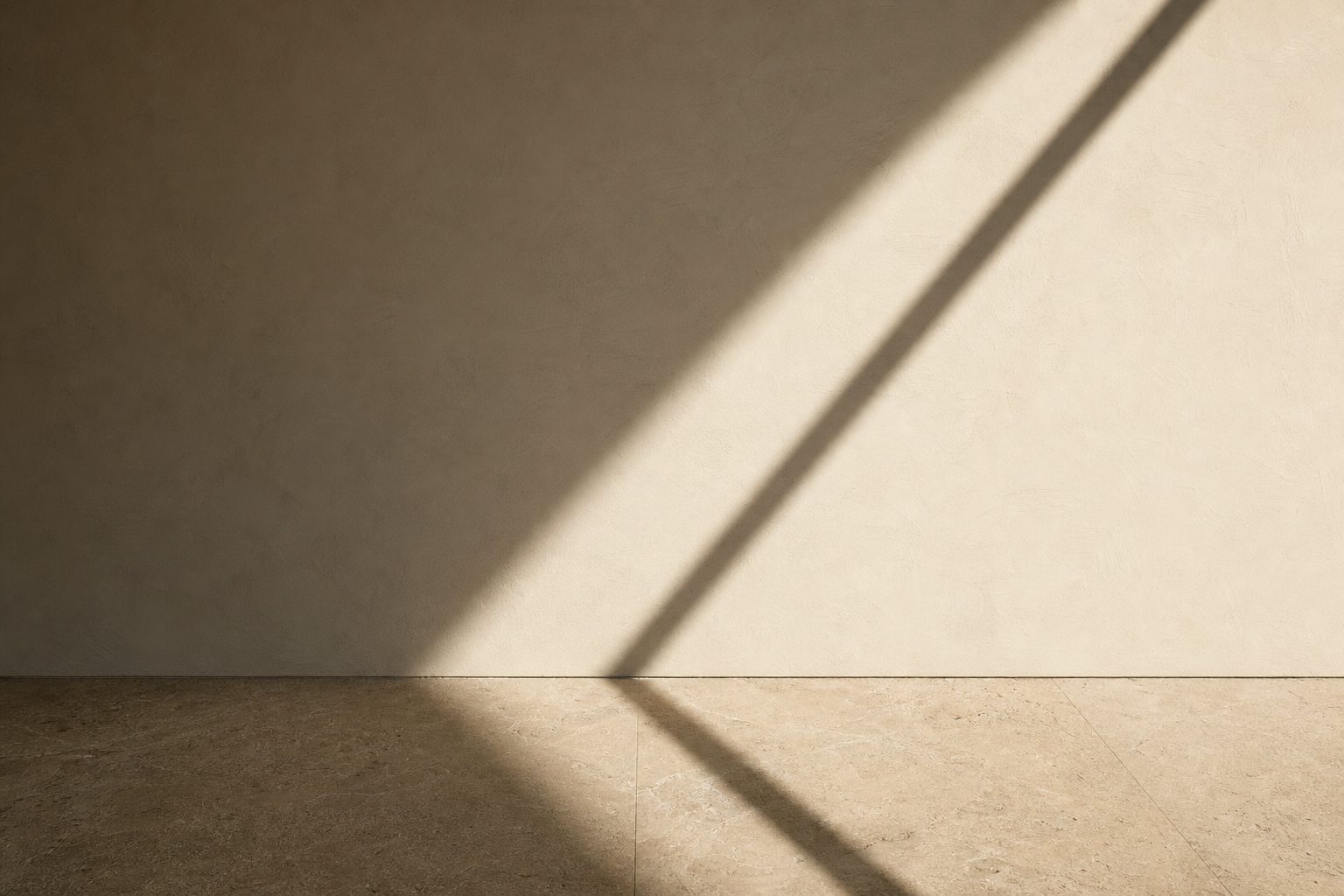 Afternoon shadow falling across plaster and limestone